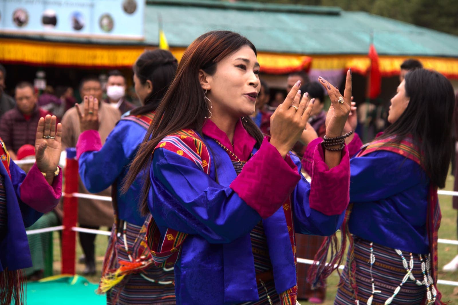 Women in traditional kira dancing at a Bhutanese festival
