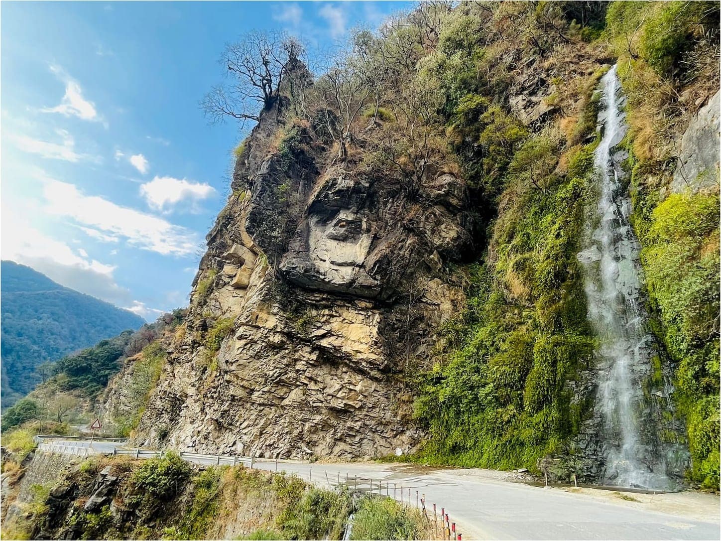 A waterfall tumbling beside a mountain road in southern Bhutan
