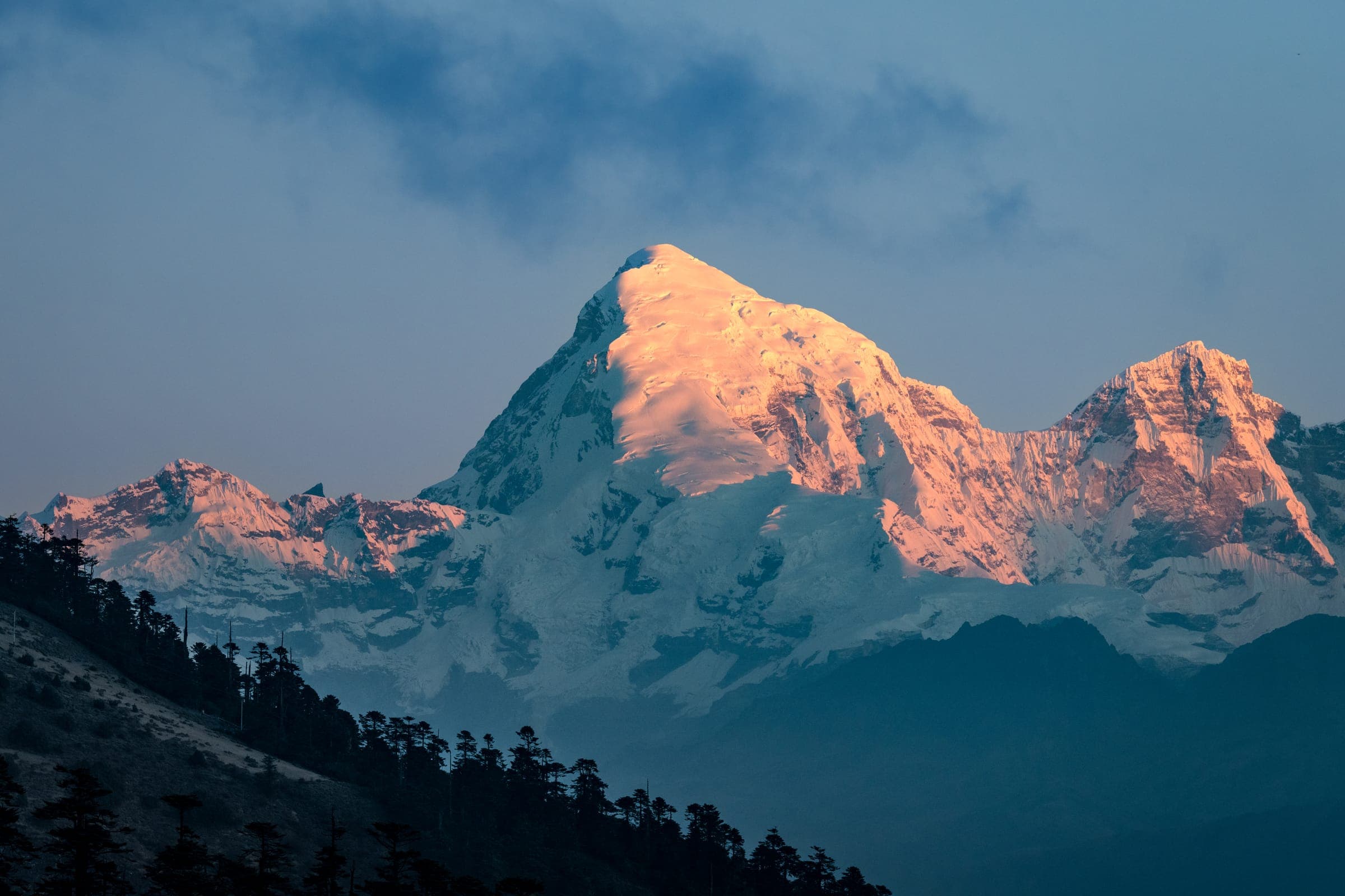 Pink dawn light on a Himalayan peak seen from Chele La pass