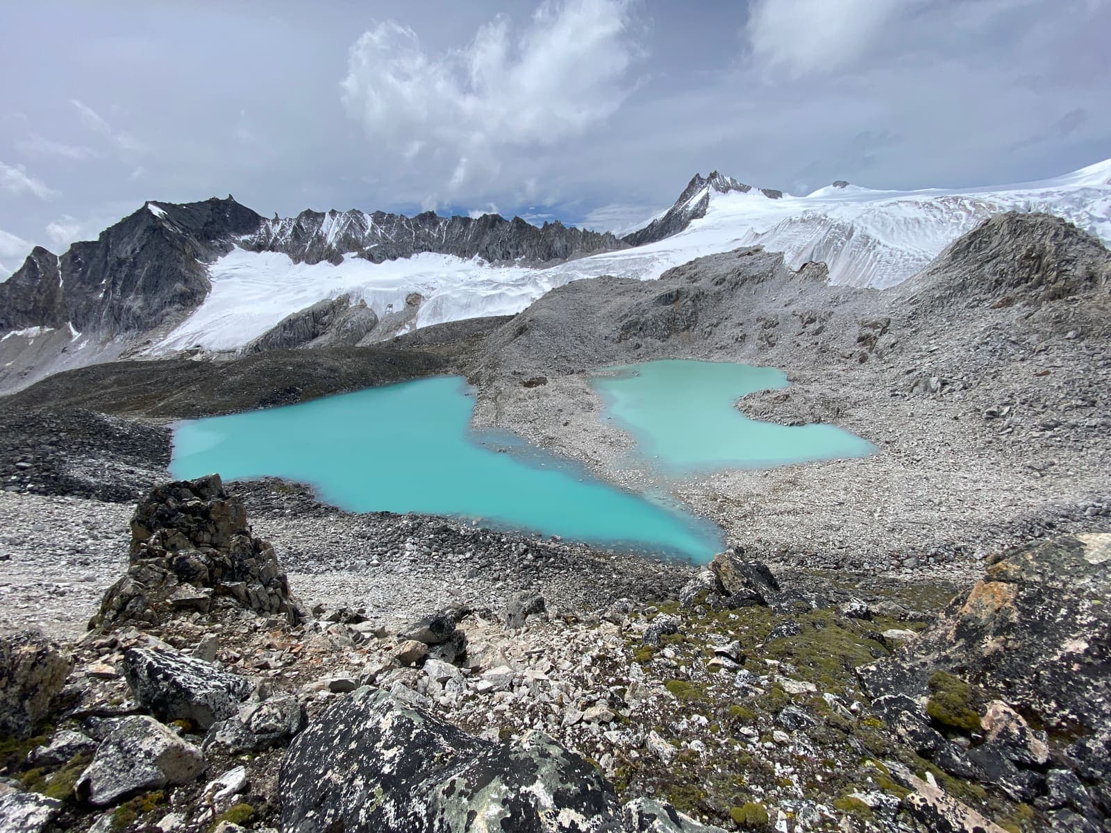 Turquoise glacial lakes beneath snow peaks