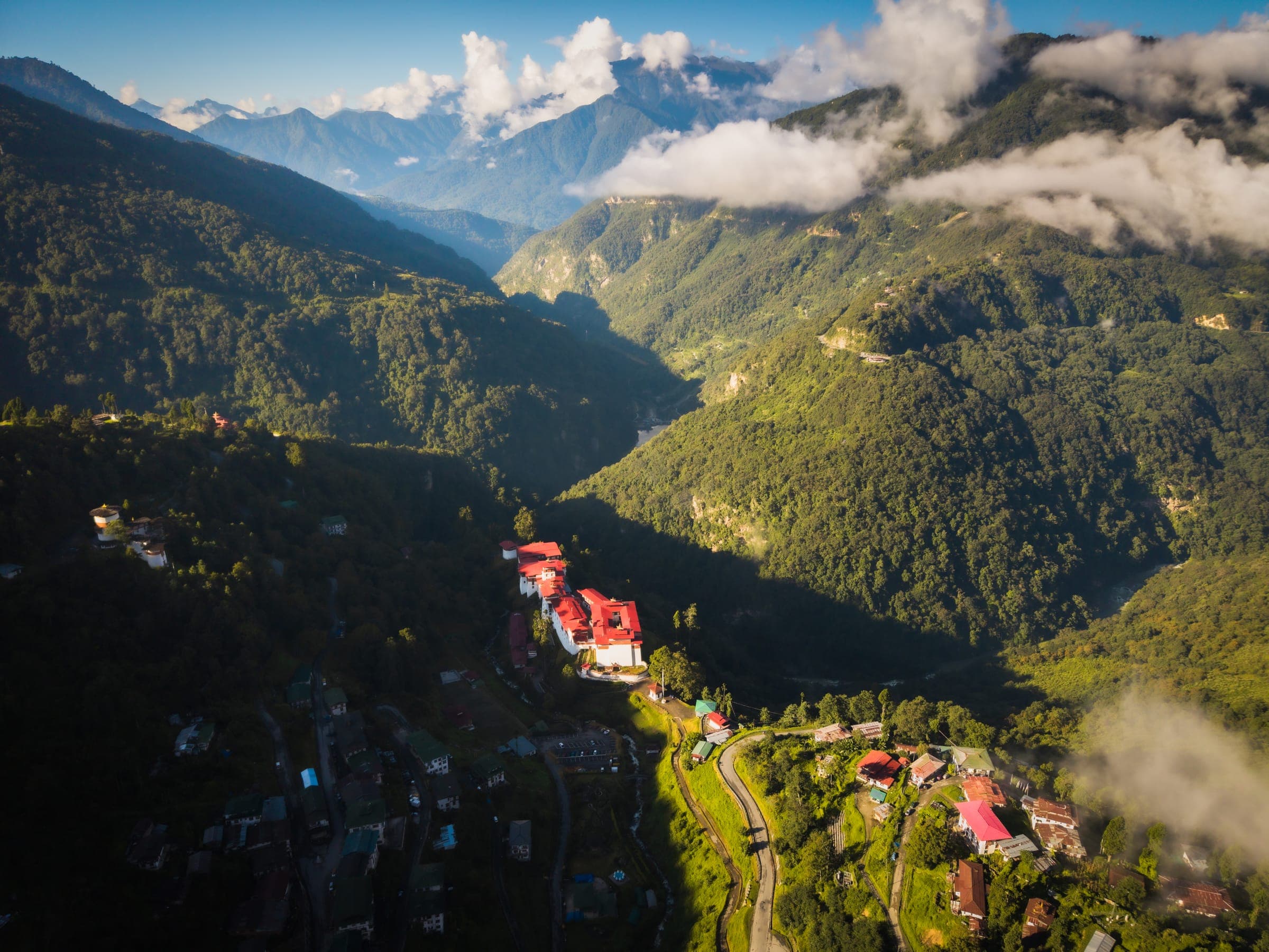 A mountain valley in golden light with a village on the ridge