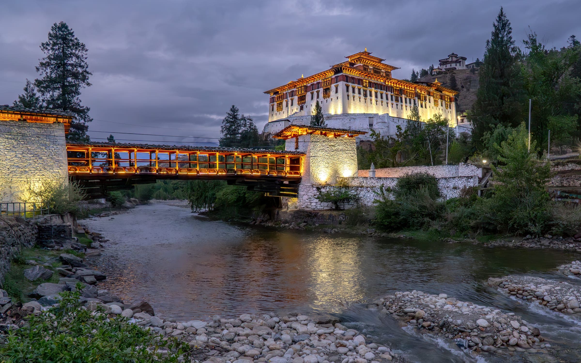 Paro Dzong and its covered bridge lit at dusk