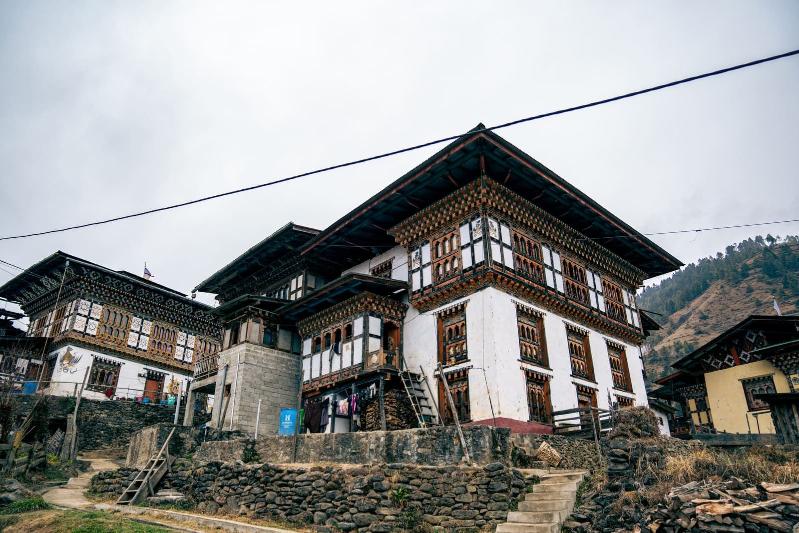 A traditional Bhutanese farmhouse with painted wooden windows