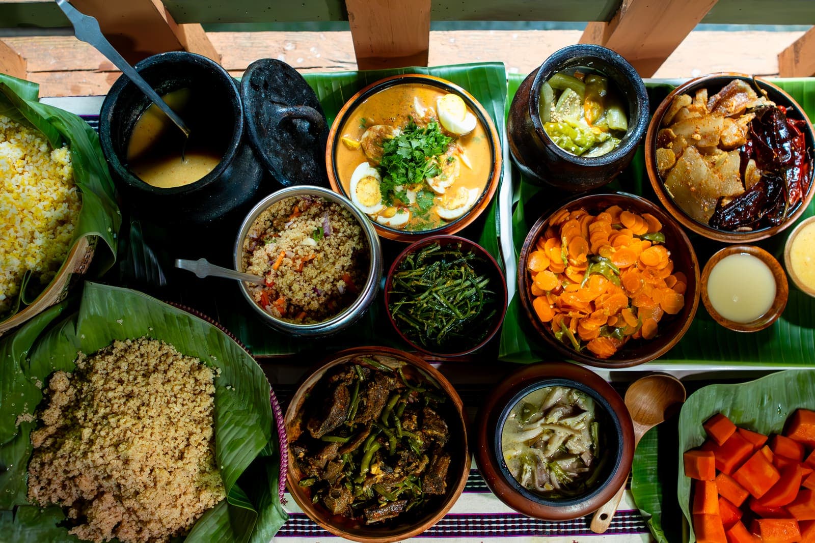 A spread of traditional Bhutanese dishes on banana leaves