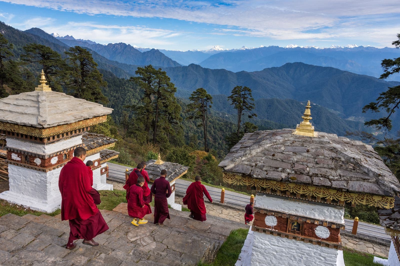 Monks walking among the chortens at Dochula Pass