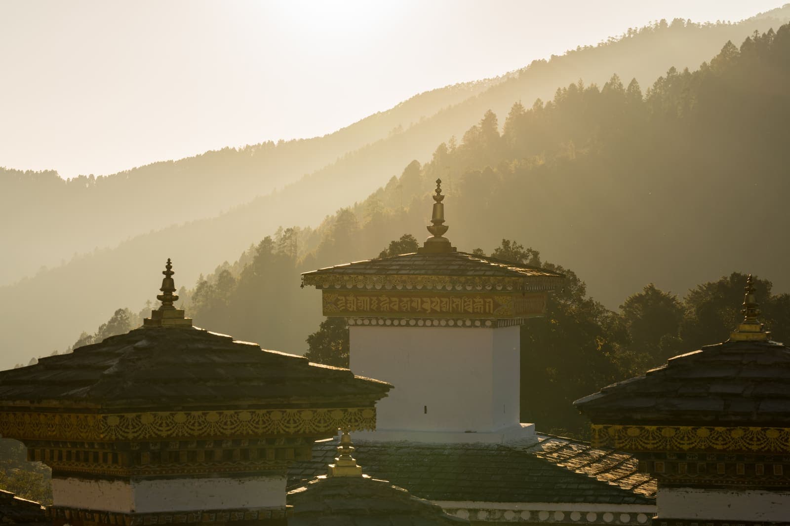 Dochula chortens in hazy golden light