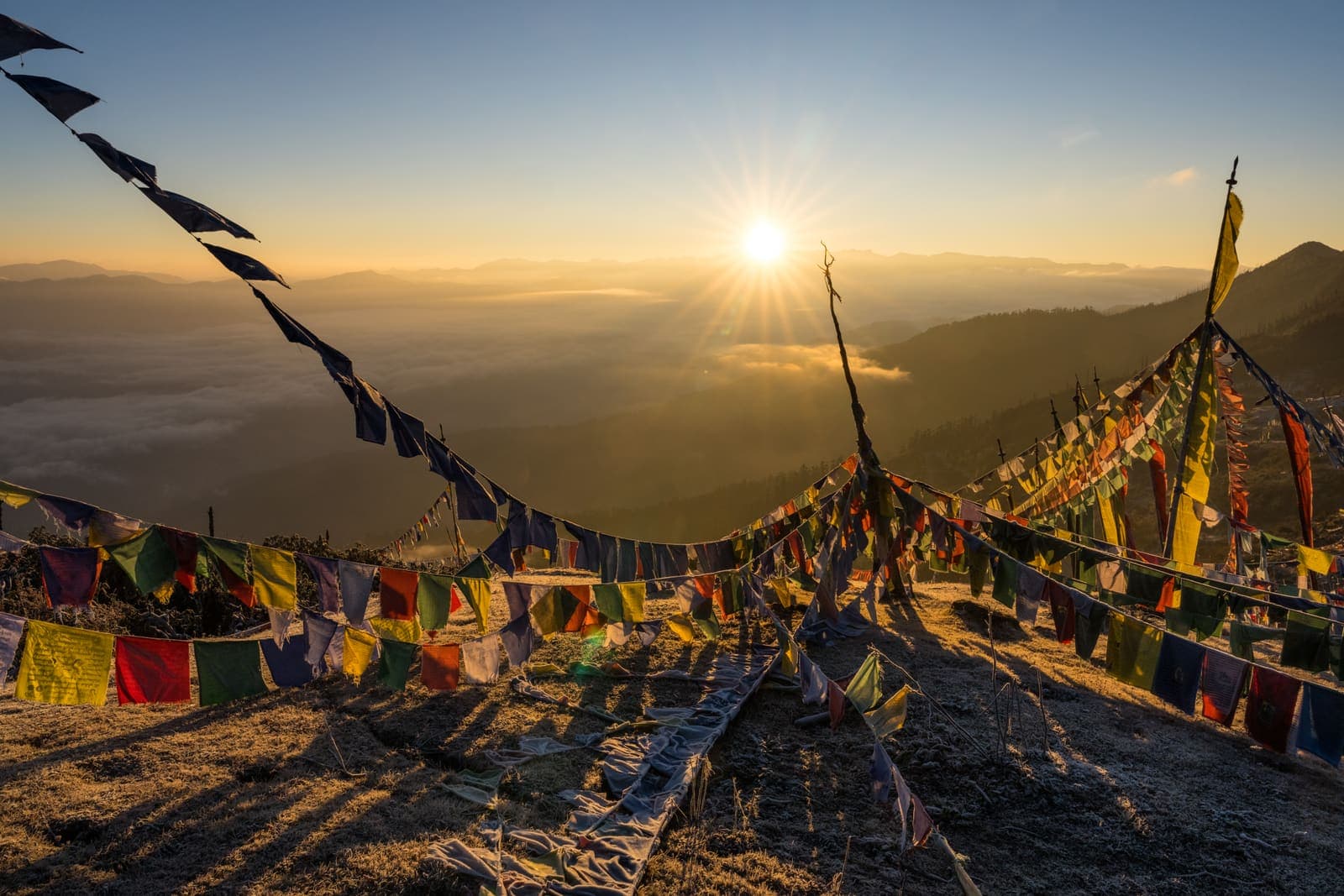 Sunrise through prayer flags on a Himalayan pass
