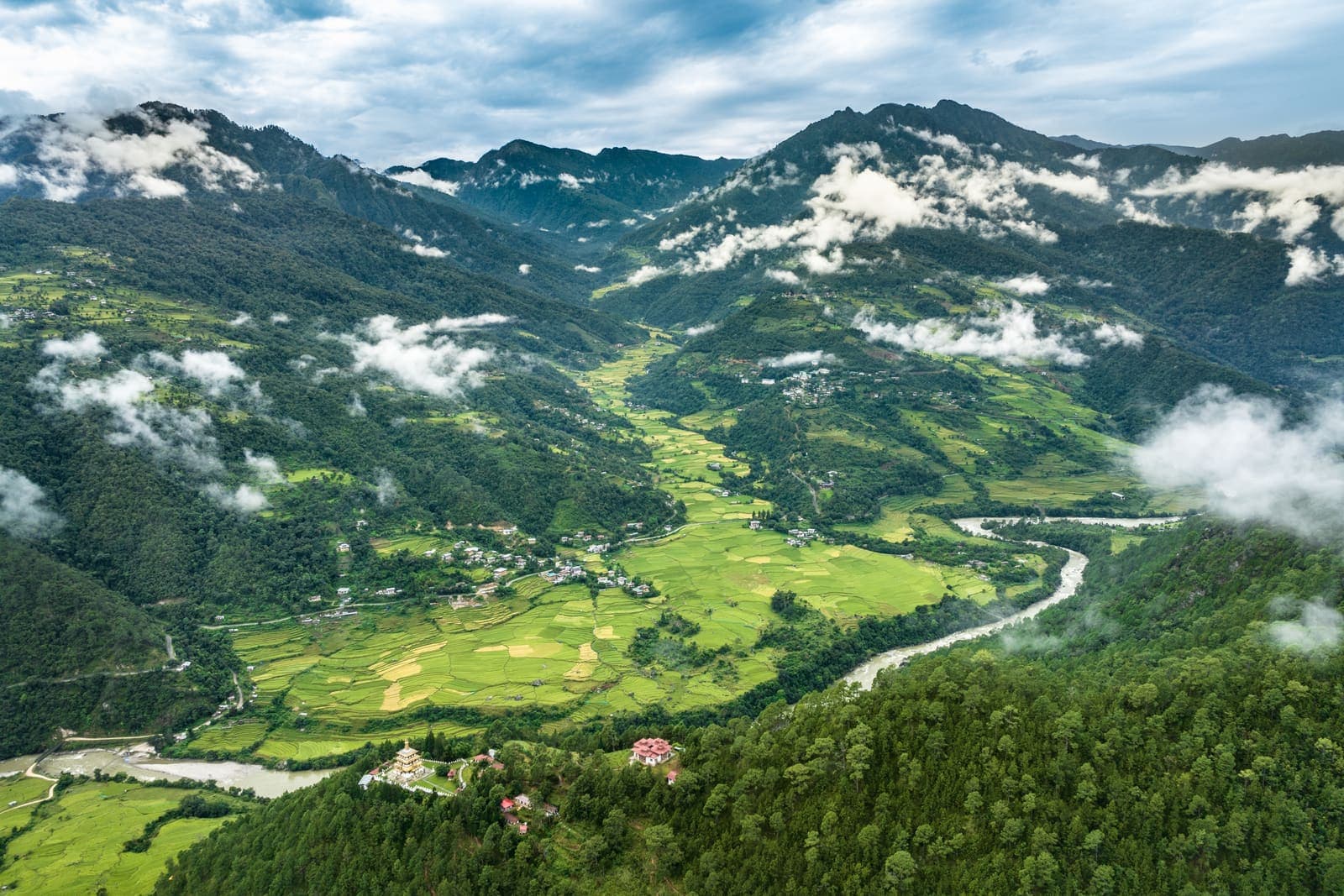 A green valley with cloud lifting off the hills
