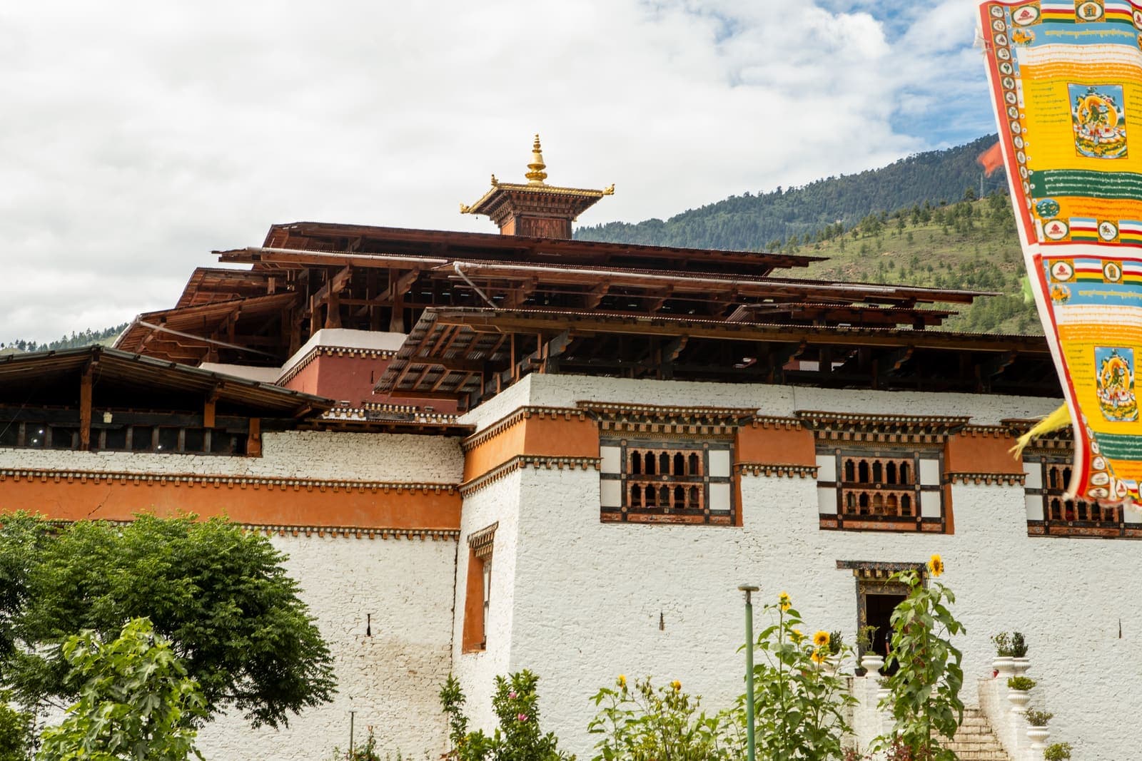 A traditional dzong with carved wooden eaves in Thimphu