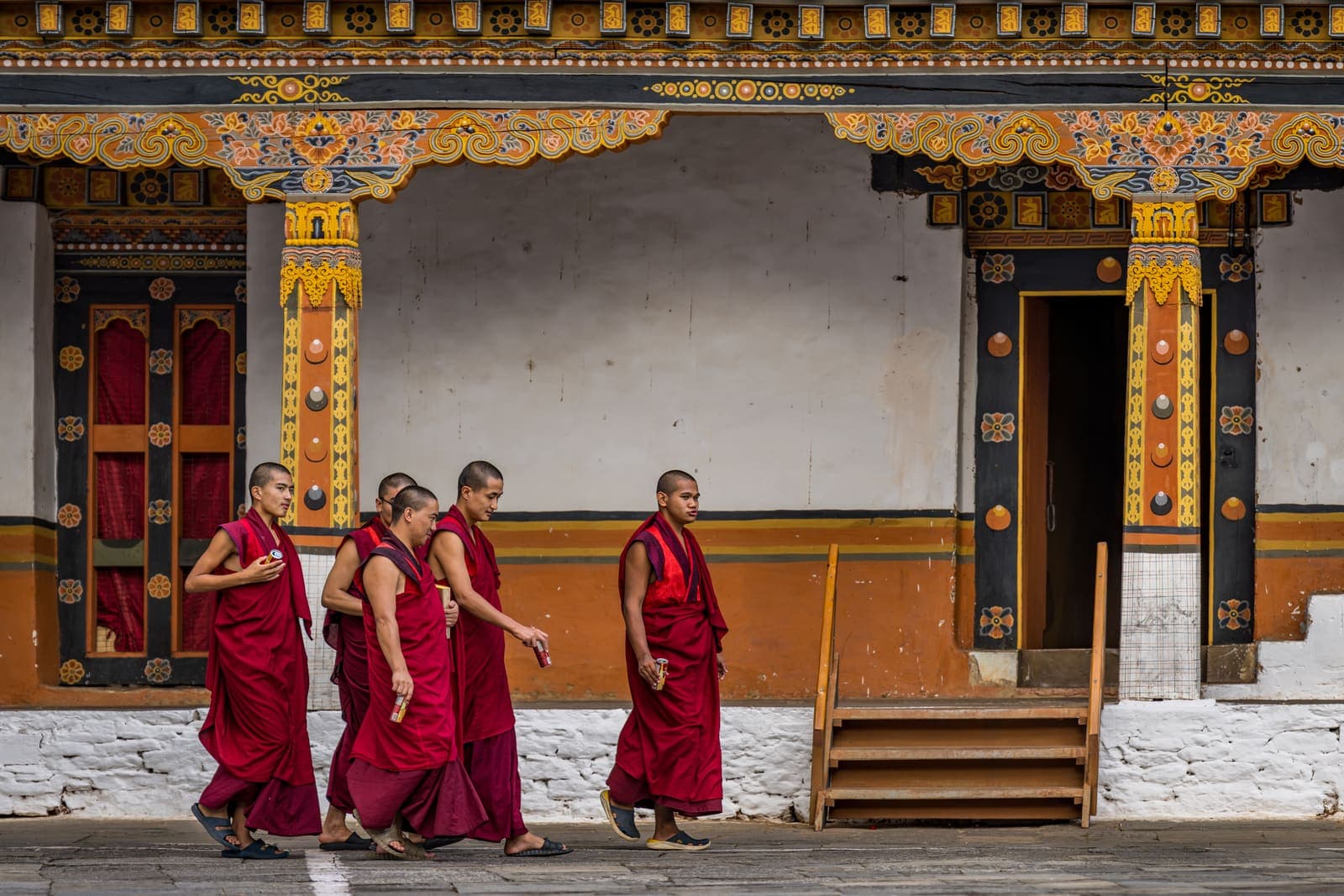 Monks walking past a temple in Punakha