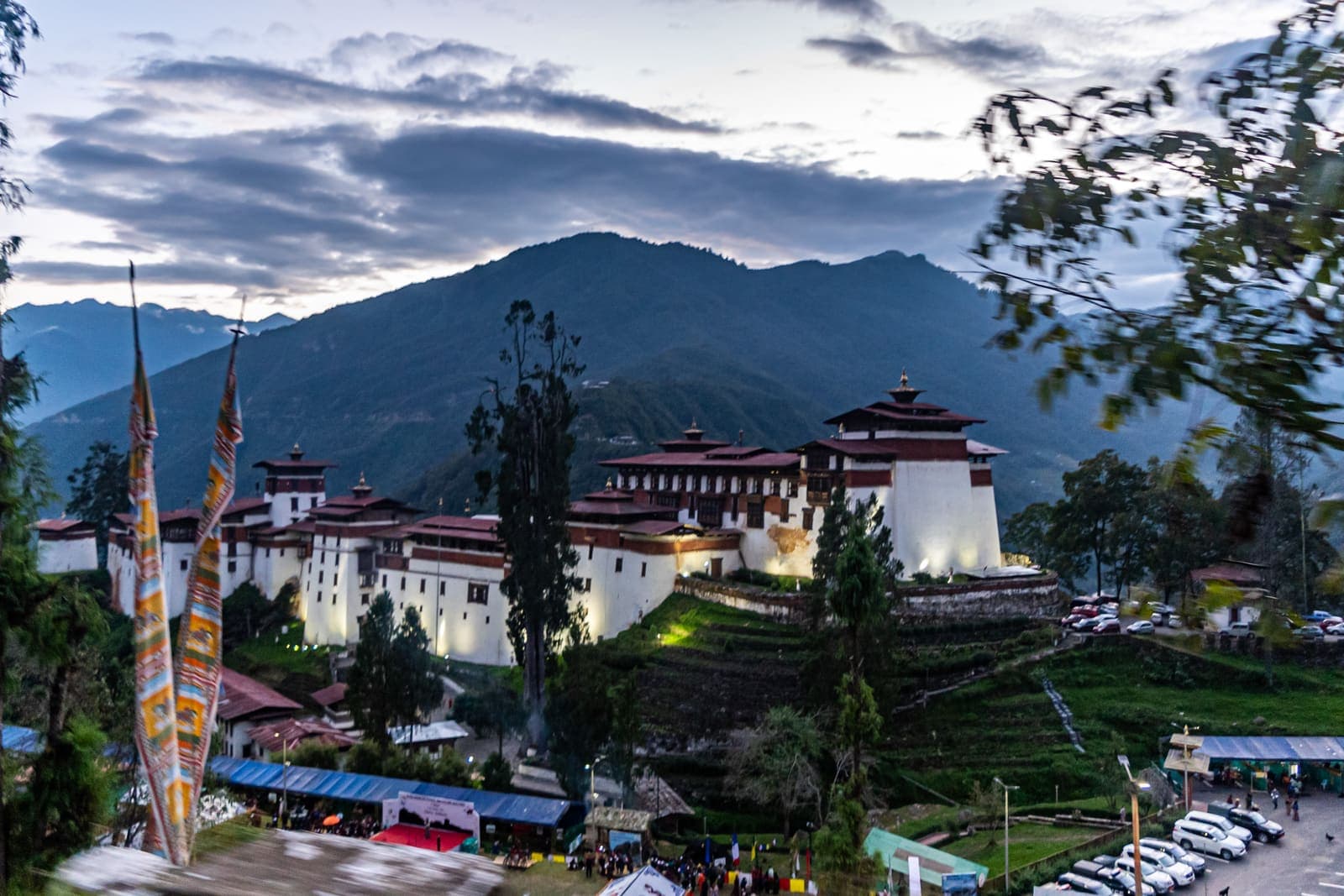 Trongsa Dzong lit at dusk beneath the mountains