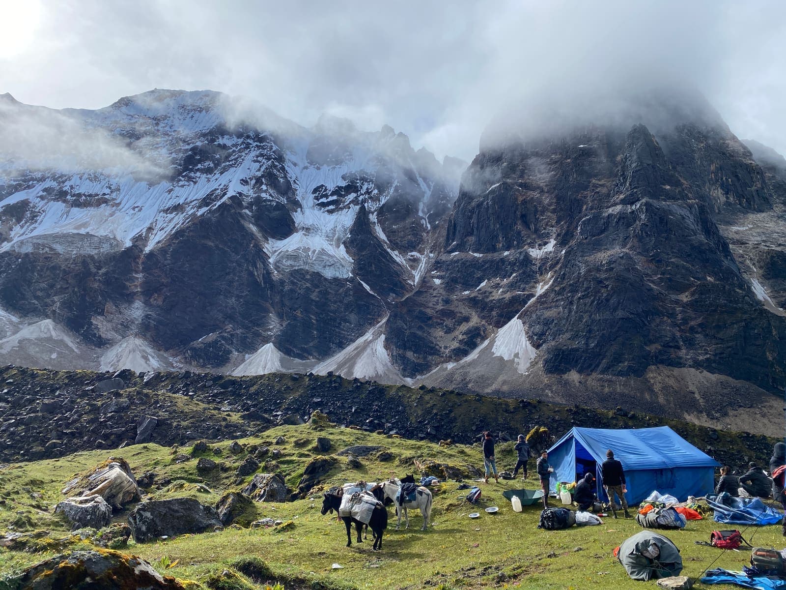A trekking camp beneath towering glaciated peaks